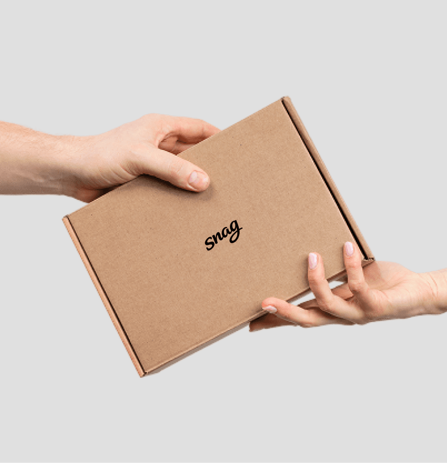 Two hands exchanging a neatly packaged SnagRx delivery box